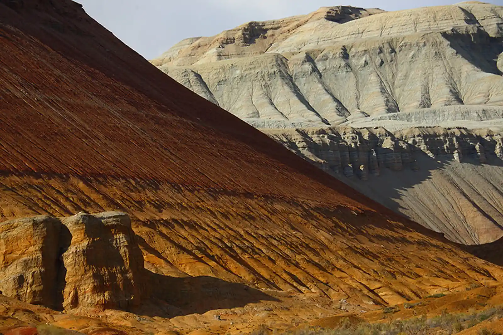 Striped red-brown and white sedimentary rock layers of the Aktau mountains
